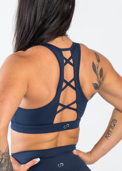 Chin to Waist with Hands on Hips Wearing Empowered Laced Back Sports Bra | Blue